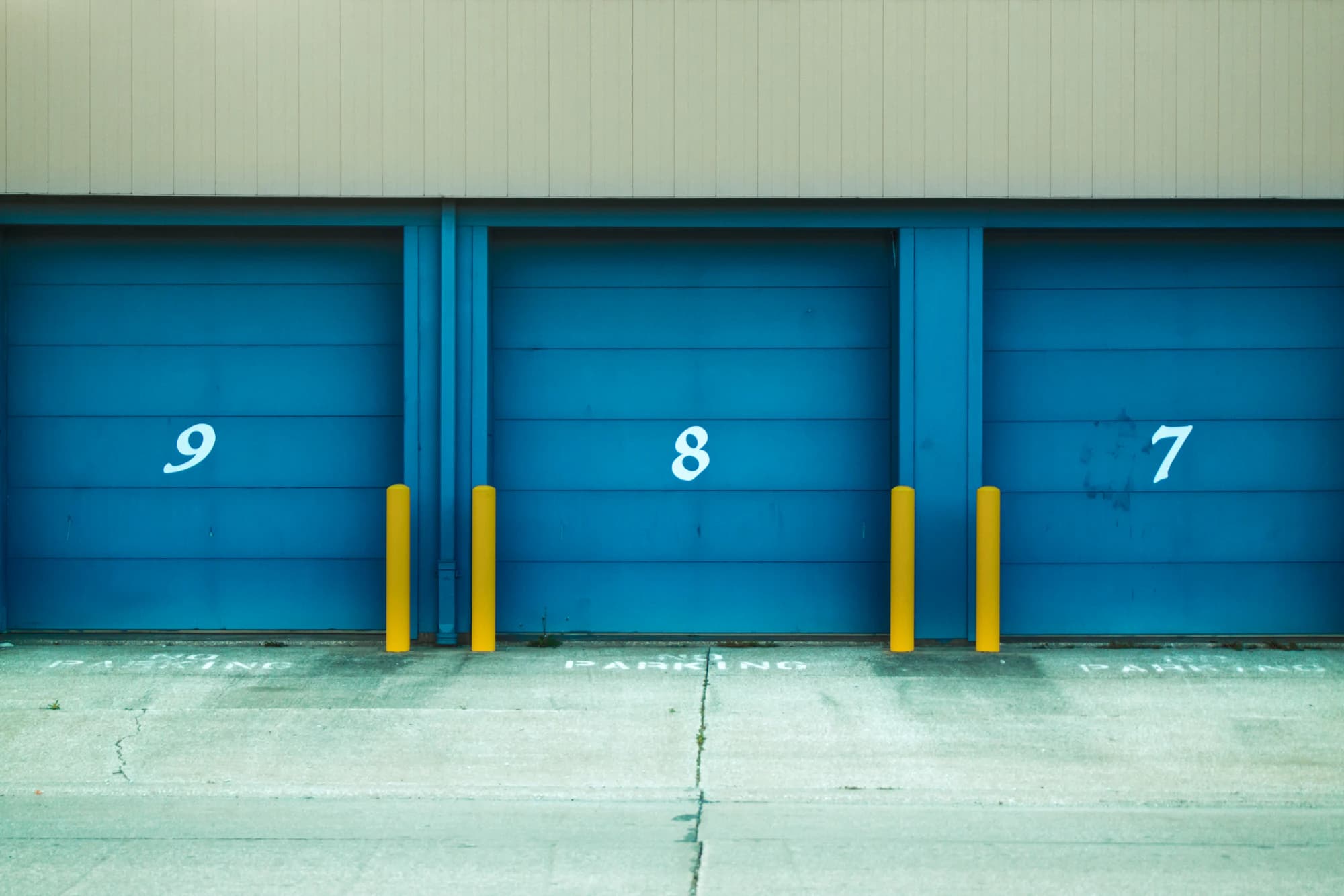Row of self-storage units with metal roll-up doors